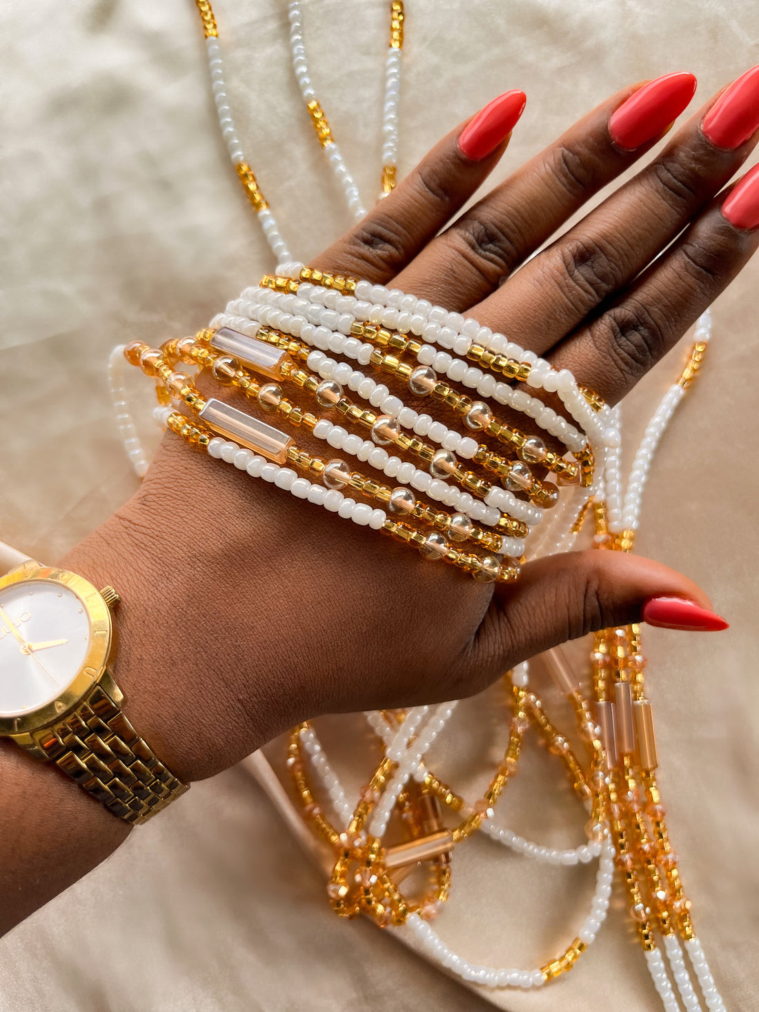 white and gold waist beads. close up.