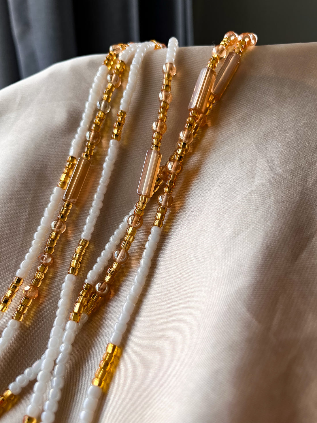 white and gold african waist beads, Close up.